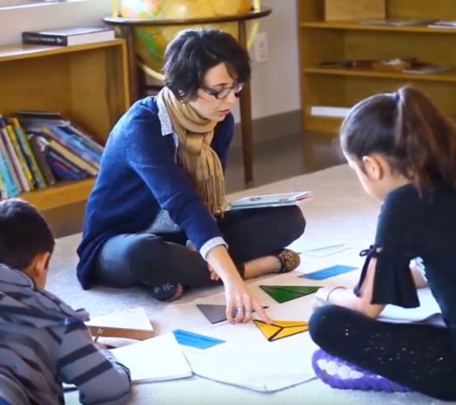 Montessori guides elementary students A Montessori Elementary School guide leading a lesson