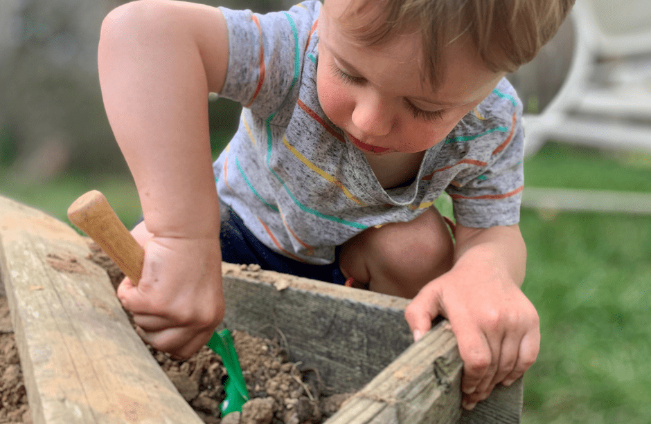 Toddler Boy gardening outdoors