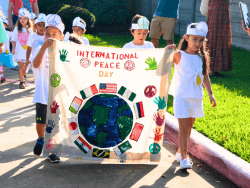 Kids participating in a Parade at Montessori House School for International Day of Peace