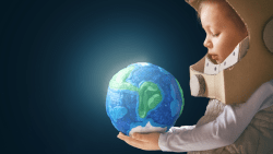 Young boy in a homemade astronaut costume looking at a globe