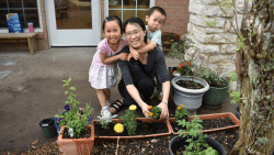 Family enjoying gardening at Montessori House for Children and Elementary School.