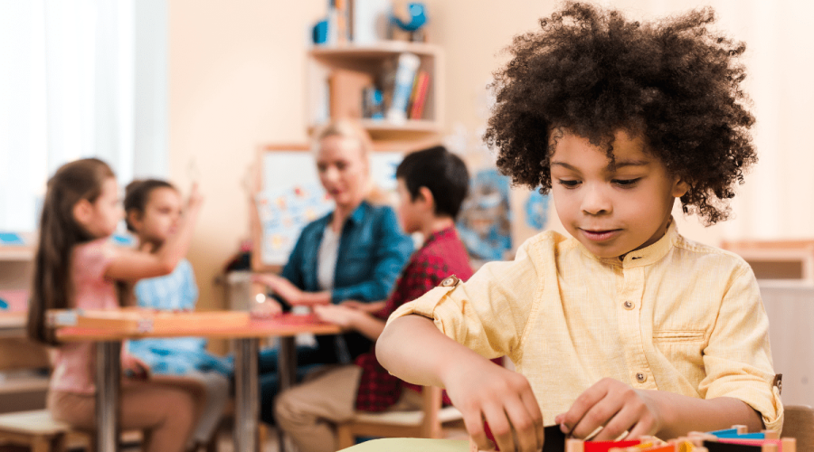 Photo of Montessori Student in classroom learning with hands on technique emphesized in Montesssori teaching and practiced at Montessori House in Richmond, Texas.