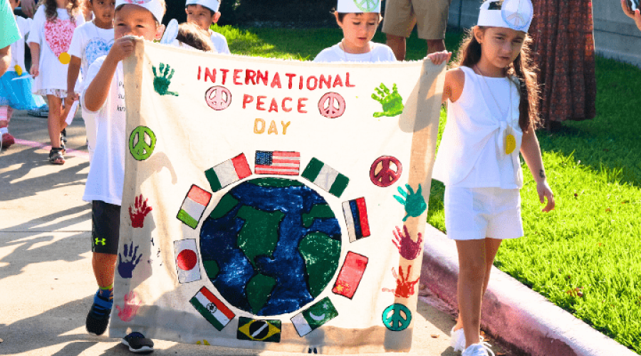 Kids participating in a Parade at Montessori House School for International Day of Peace